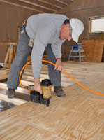 Man Nailing plywood subfloor